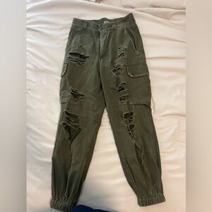 olive green ripped cargo pants. tight band around the ankles. size 6